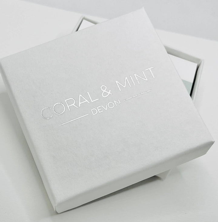 Coral and mint Huggies comes in a beautiful gift box.