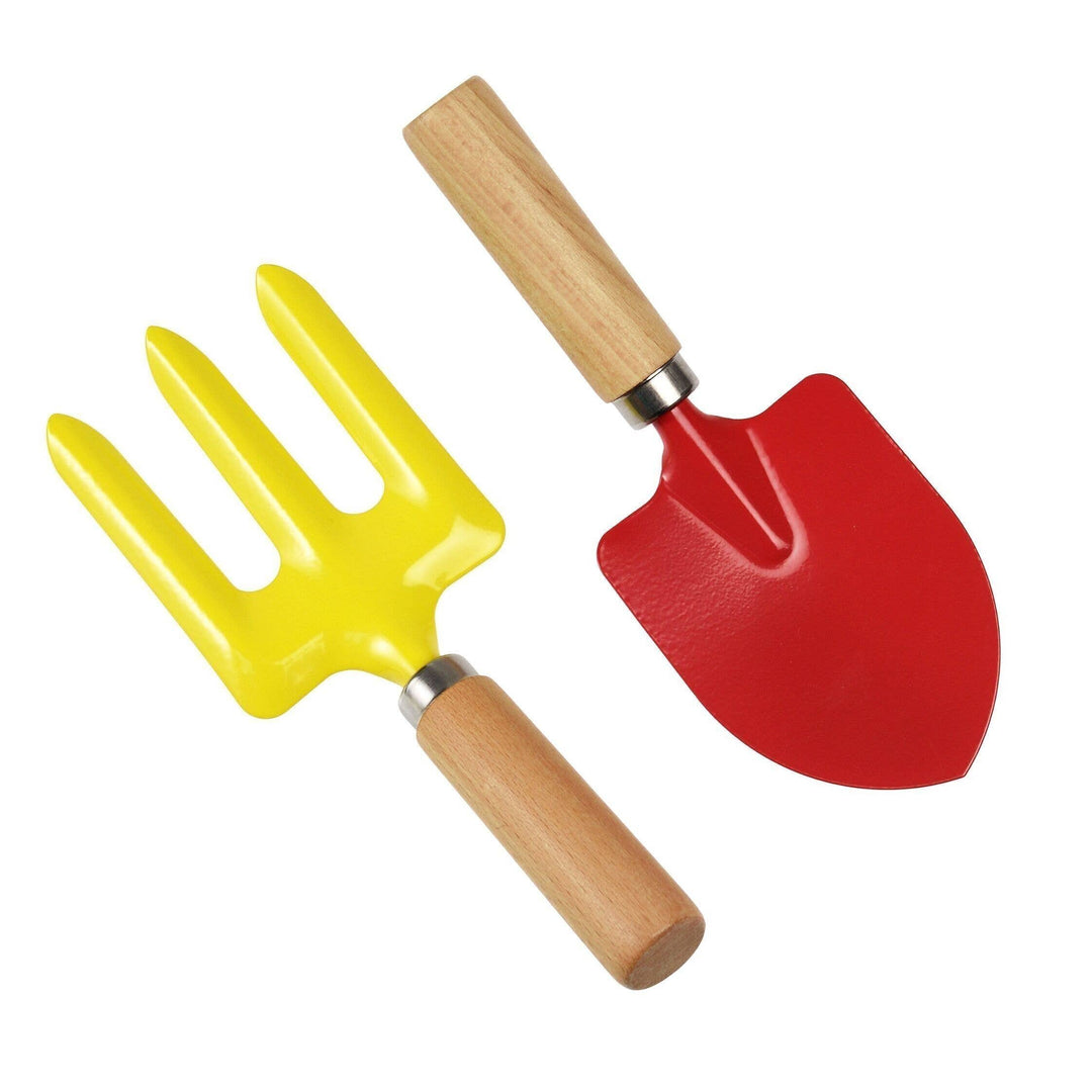 First gardening tools for kids. Red space and yellow fork.