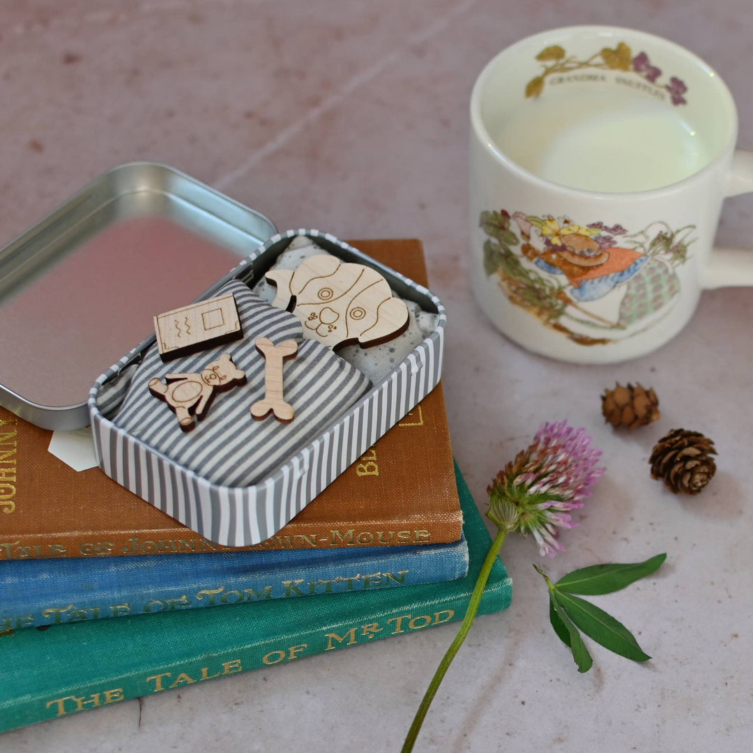 Mini maple wood dog is ready for its new home, &; is looking for a lovely owner to help look after it. Each dog is housed in a sweet stripy tin.