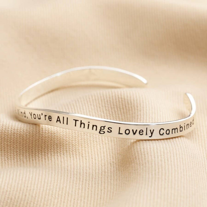 Adjustable silver bangle with a beautiful message. You're beautiful amazing, and kind you're all lovely things combined" inscribed on the bangle.