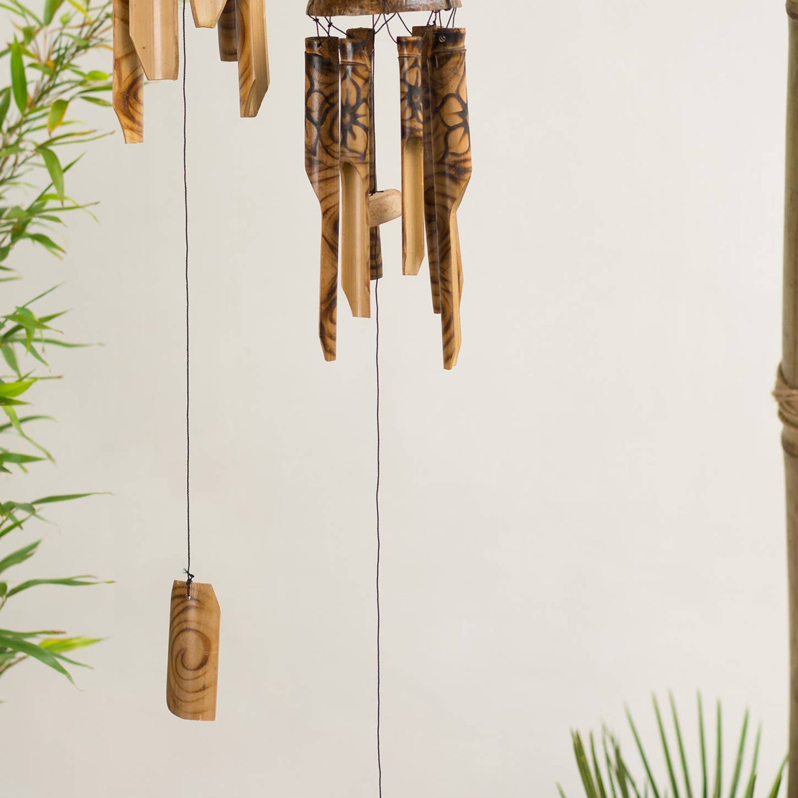 Wooden wind chime with natural patterns on a light background