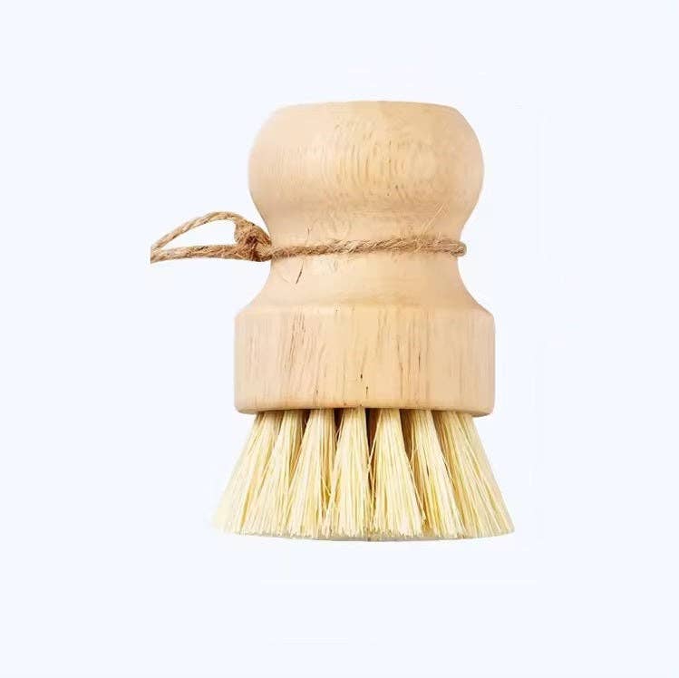 Wooden dish brush with bristles on a white background