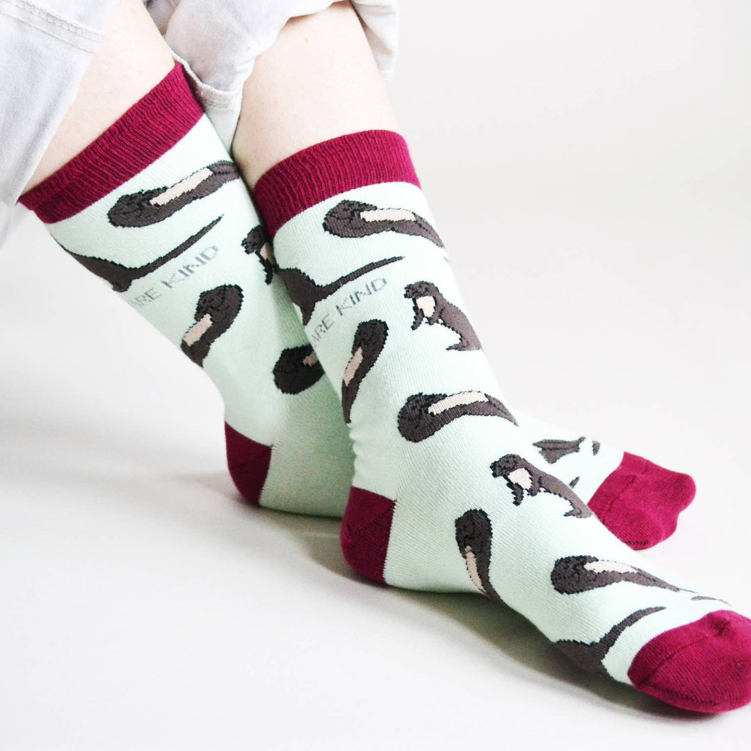 Bamboo socks with otter print on light blue and burgundy socks.