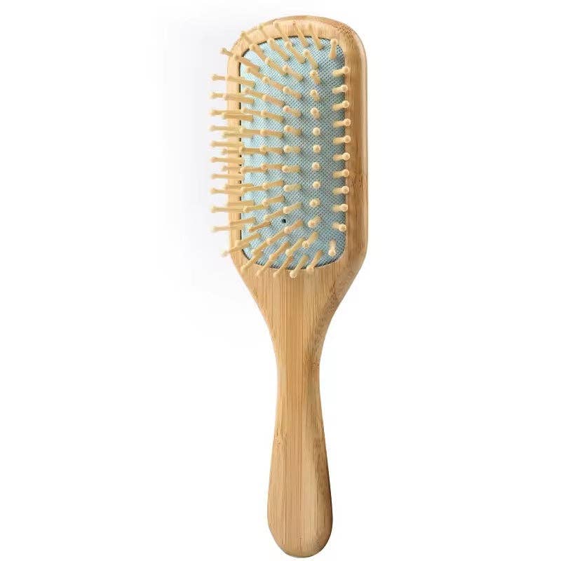 Wooden hairbrush with bristle head on a white background
