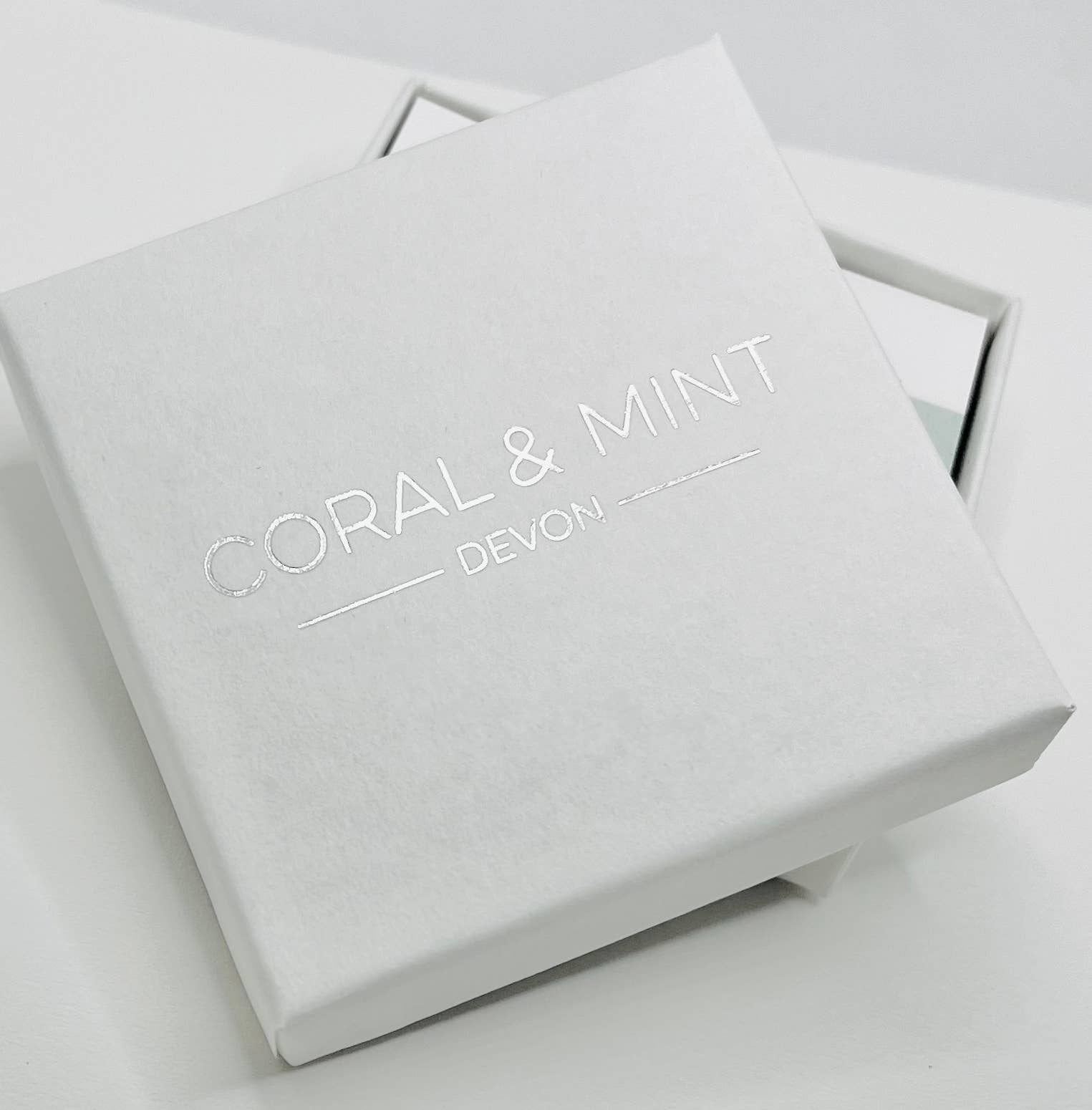Coral and mint Huggies comes in a beautiful gift box.
