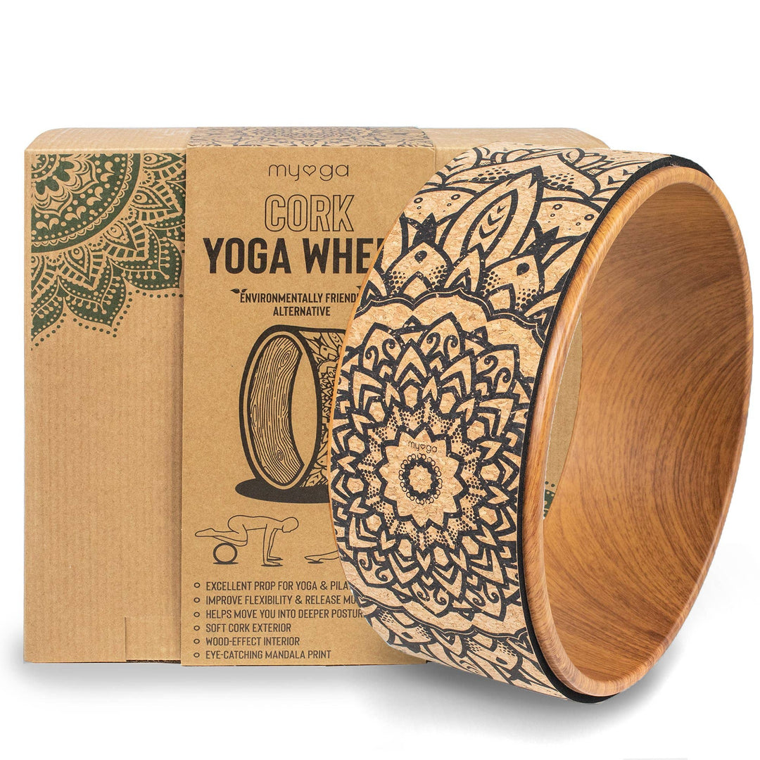 A cork yoga wheel with a decorative pattern, placed next to its packaging box which has &