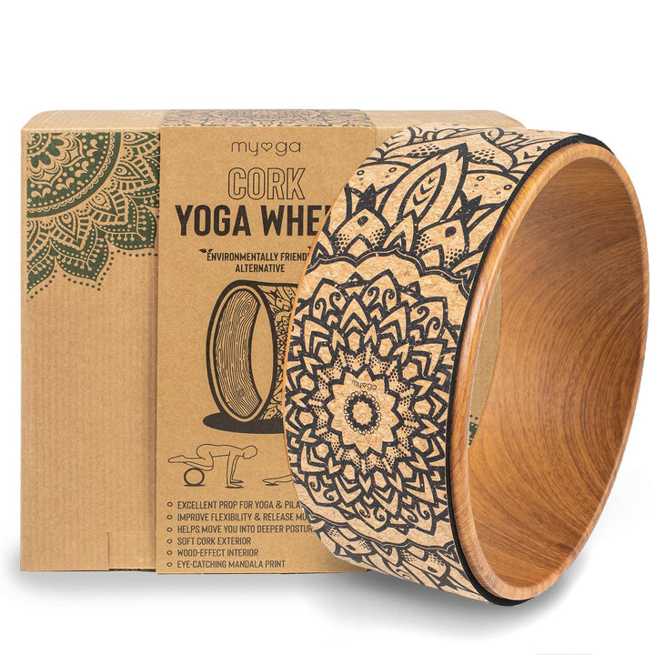A cork yoga wheel with a decorative pattern, placed next to its packaging box which has &