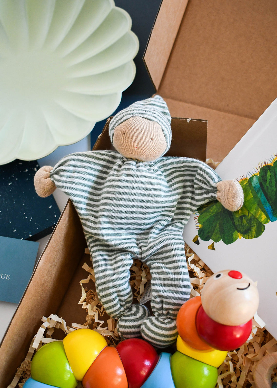 Eco Friendly New Baby gift box - Little caterpillar. Includes the hungry caterpillar board book, wooden rainbow classic world toy, striped comforter plush and wooden teether.