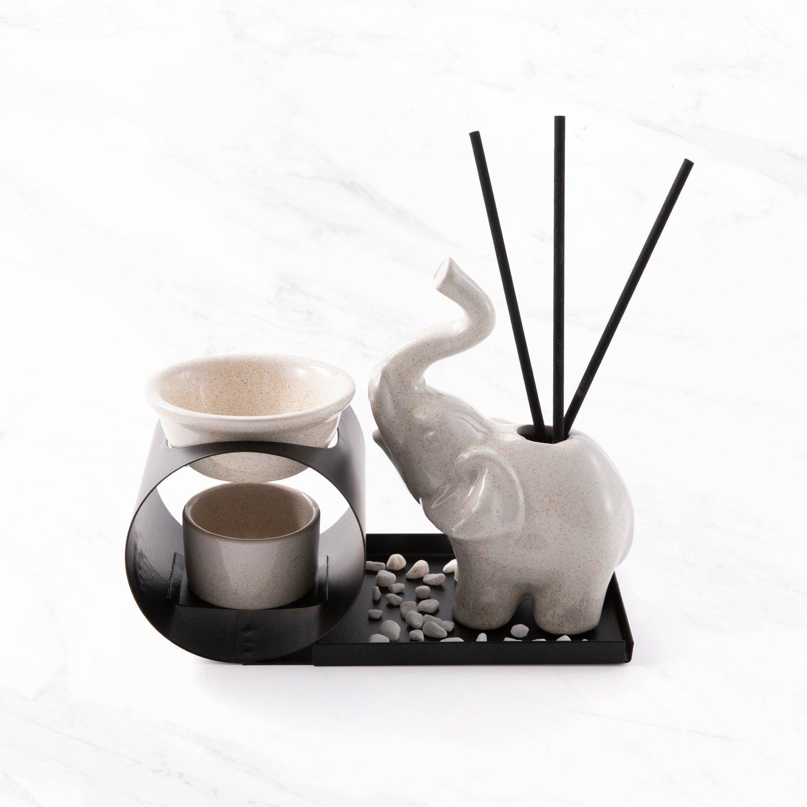 Decorative set with elephant-shaped diffuser and candle holder on a white background
