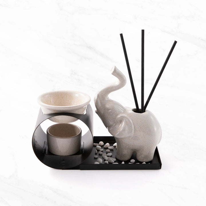Decorative set with elephant-shaped diffuser and candle holder on a white background