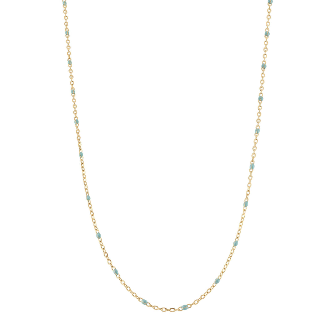 Gold chain necklace with small beads on a white background