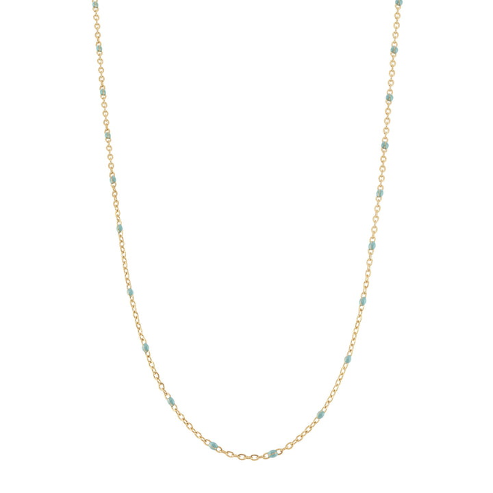 Gold chain necklace with small beads on a white background
