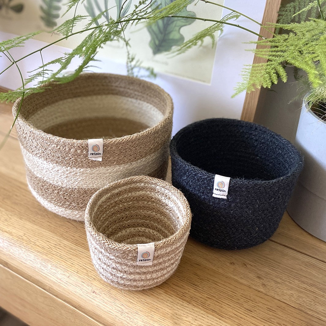 Natural Jute Basket Set – Pebble Design Large basket cream and brown with horizontal lines, medium basket plain black, small basket white and brown with horizontal lines 