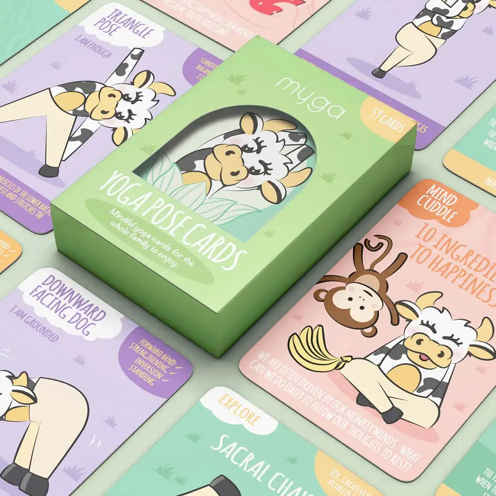 A product image featuring a green box of 'myga yoga pose cards' with illustrations of animals on the cards, placed on a background with various colorful yoga pose cards displayed.