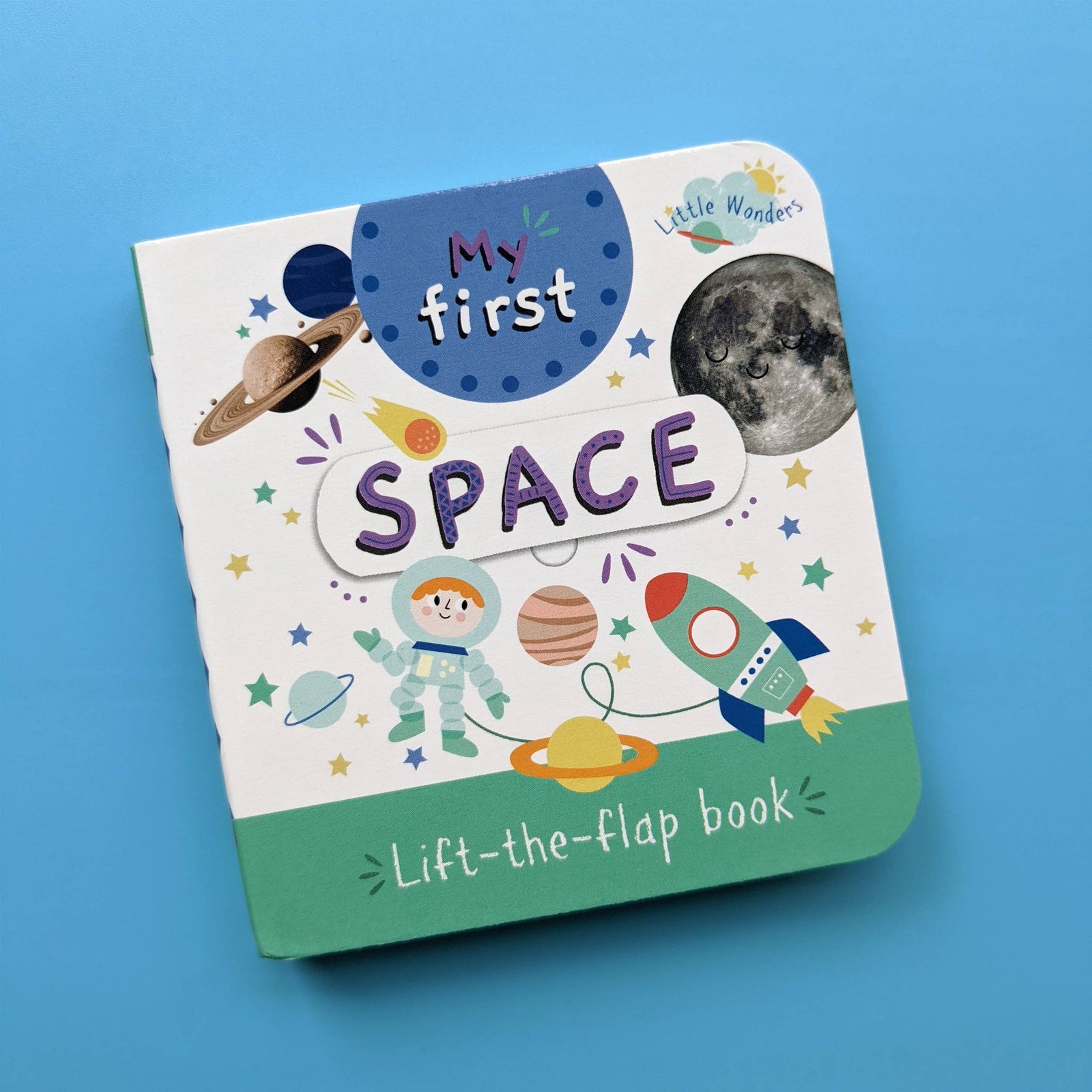 Children's book titled 'My First Space' with space-themed illustrations on a blue background