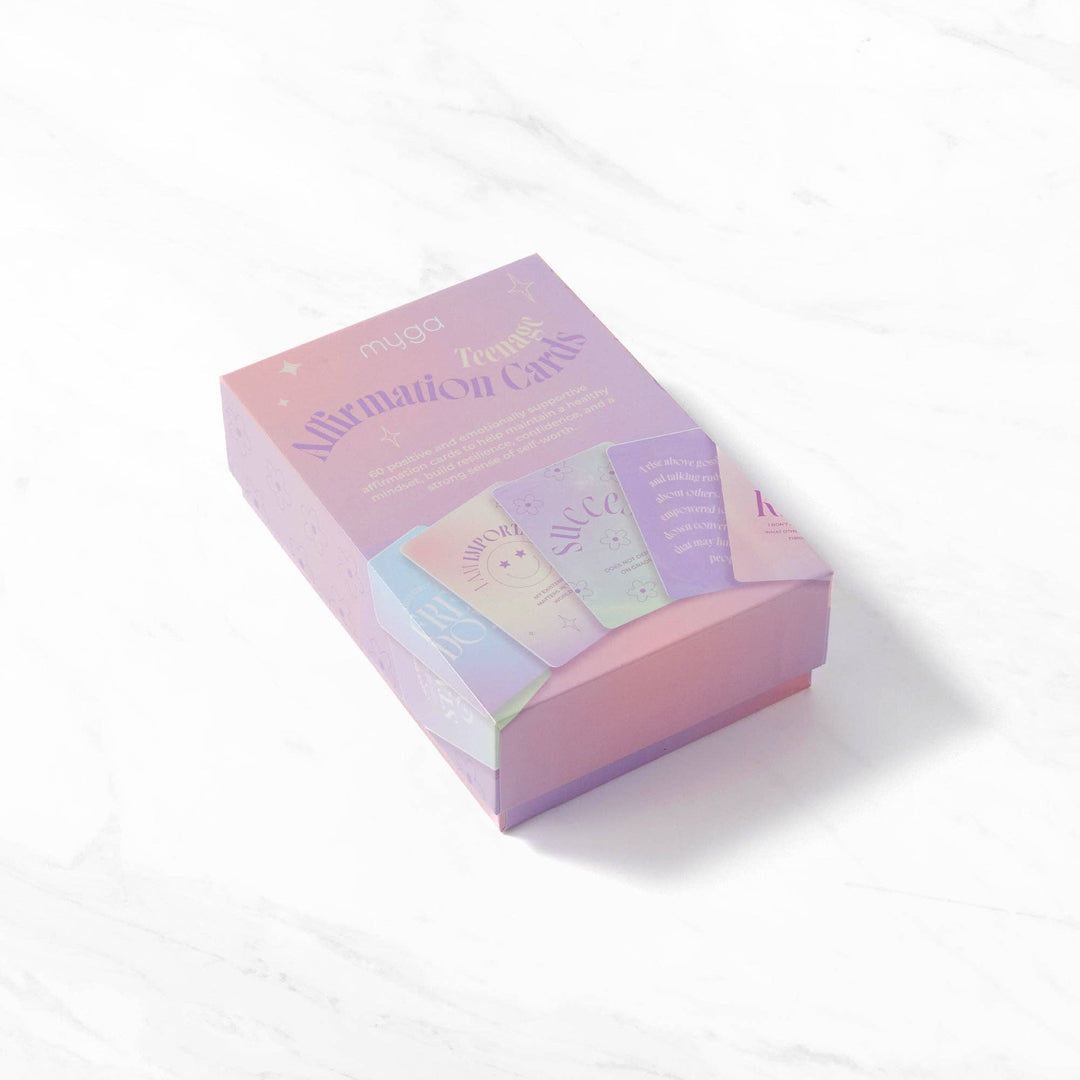 Pastel-colored box of affirmation cards on a white background