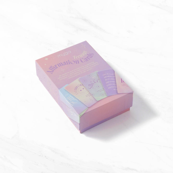 Pastel-colored box of affirmation cards on a white background
