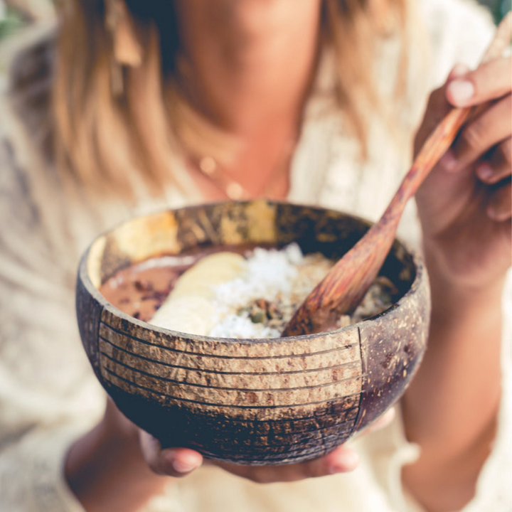 Natural coconut bowl & spoon with a striped pattern.