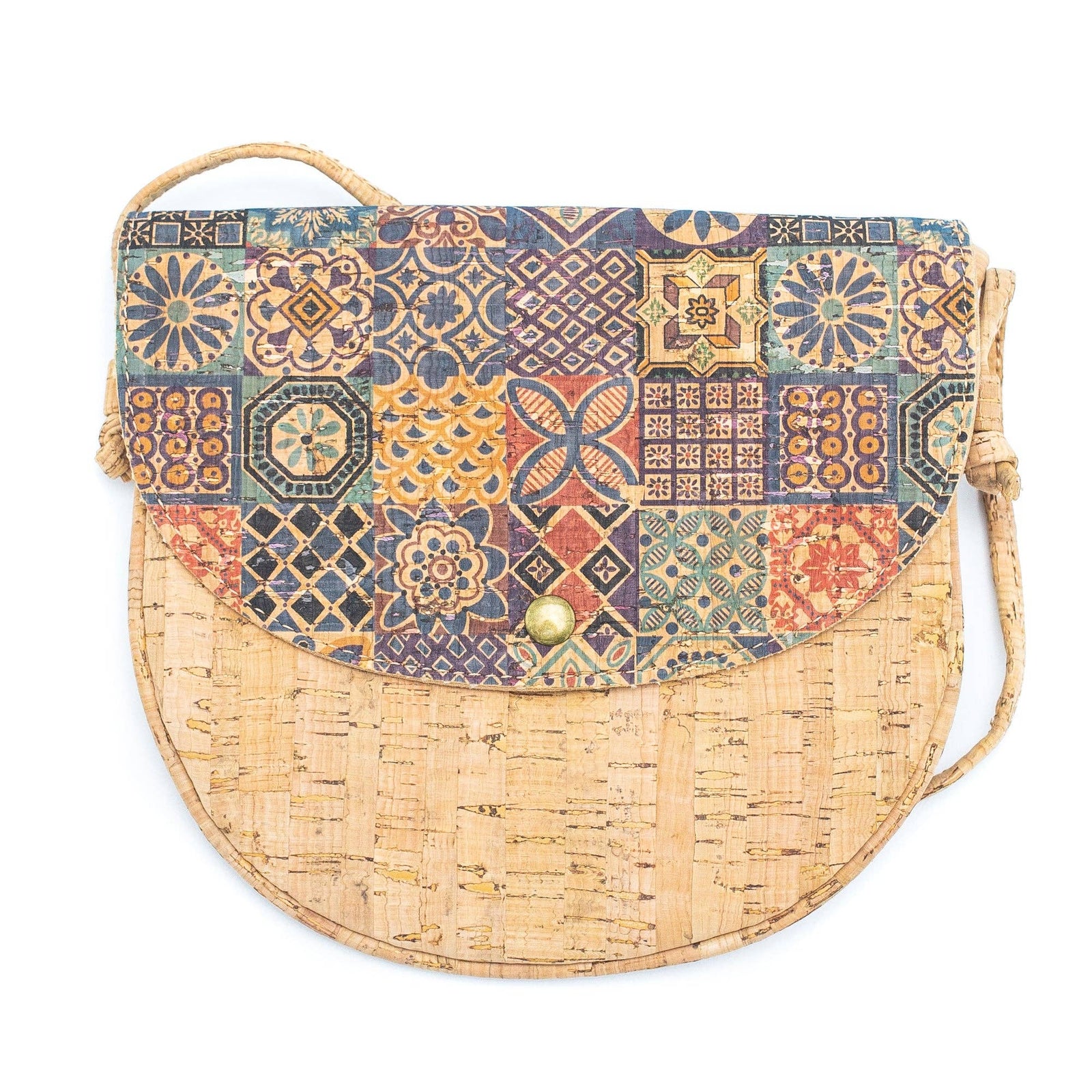 A natural cork messenger bag with multicolored geometric patterned cork panels and a beige cork strap.