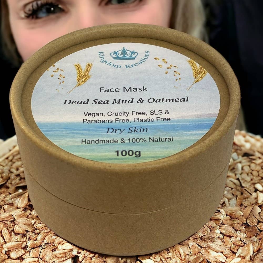 A kraft tube packaging of a natural face mask with Dead Sea mud and oatmeal. The label indicates it is vegan, cruelty-free, and handmade.
