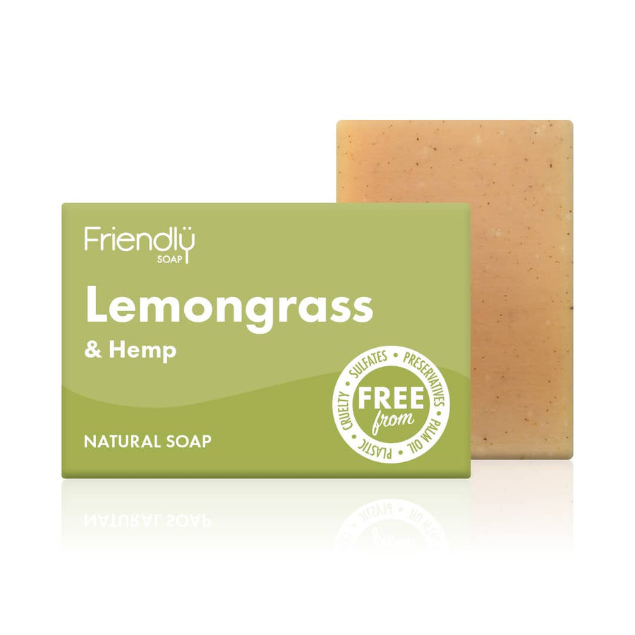 A bar of lemongrass and hemp natural soap next to its packaging, which is green and white with the product name and branding.