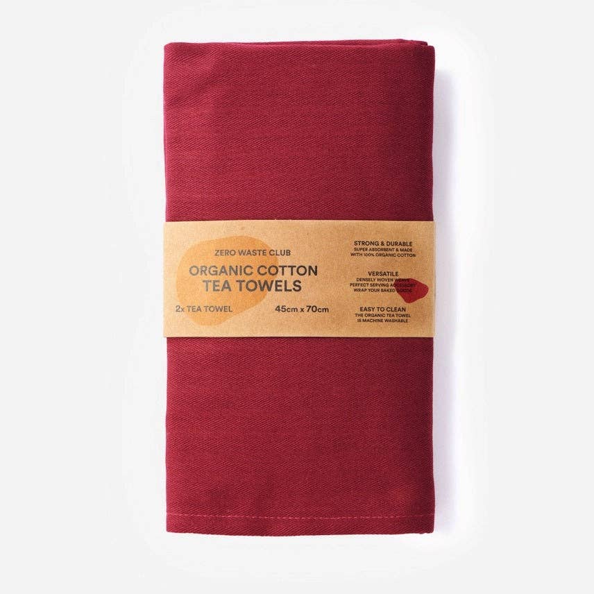 Red organic cotton tea towel with a Zero Waste Club label on a white background