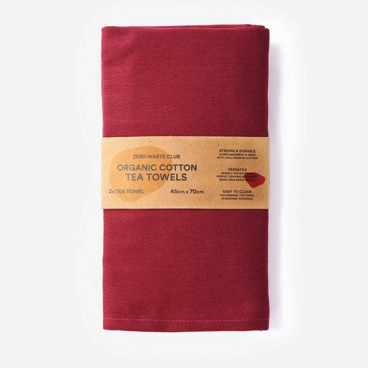 Red organic cotton tea towel with a Zero Waste Club label on a white background