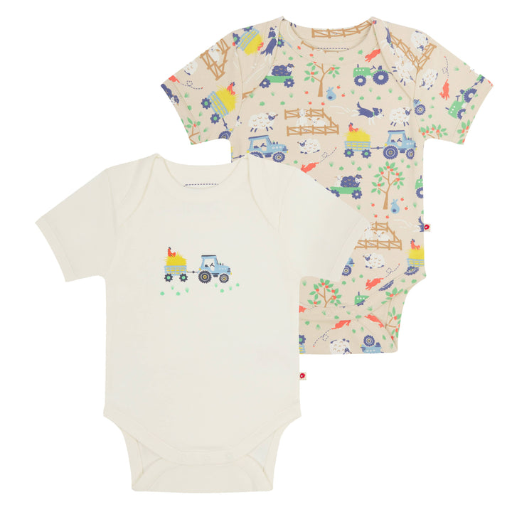 Double pack of organic cotton baby bodysuits. One bodysuit features an all-over farm print on a beige base with tractors and animals.