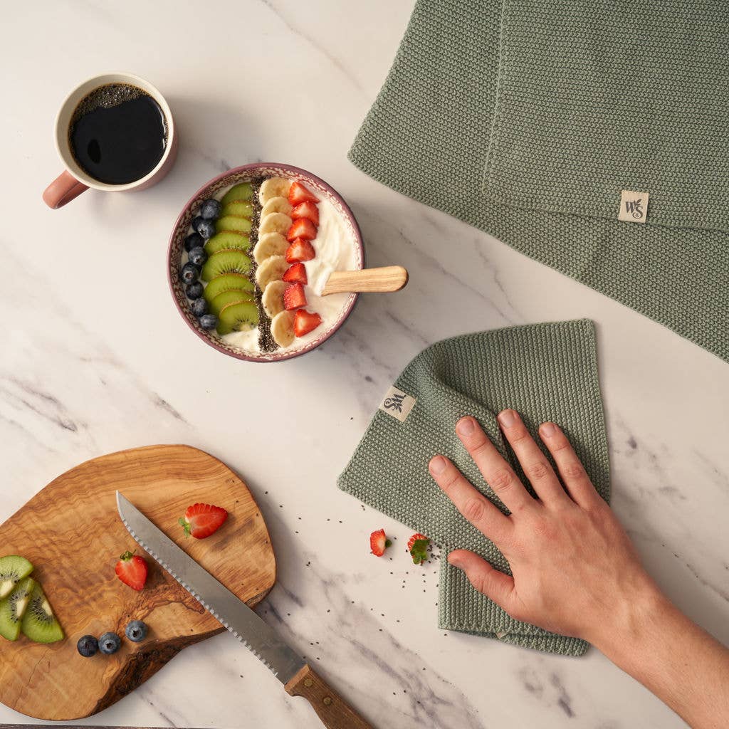 Organic cotton dishcloth in moss green colour.