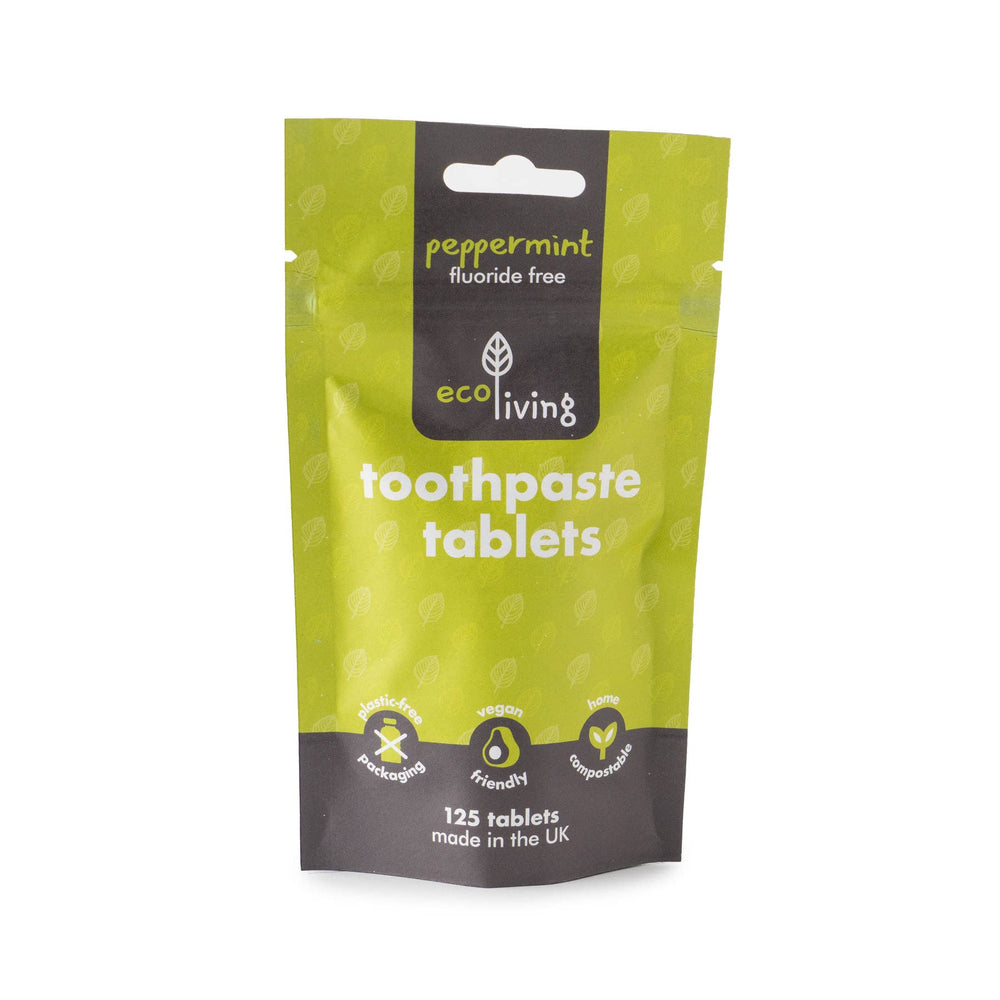 Green package of eco living toothpaste tablets on a white background