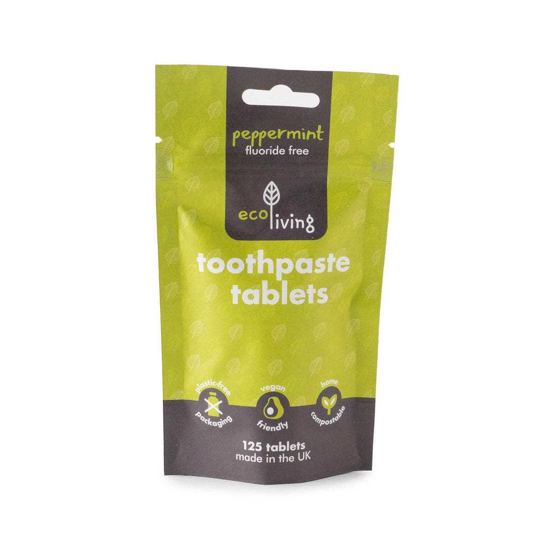 Green package of eco living toothpaste tablets on a white background