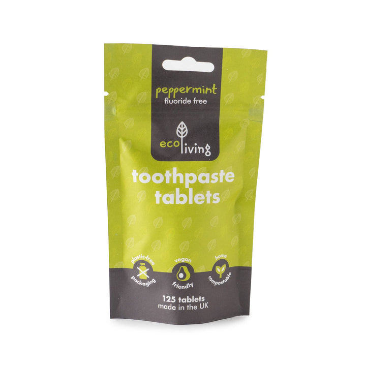 Green package of eco living toothpaste tablets on a white background