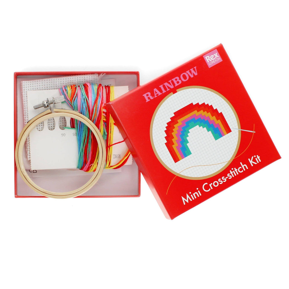 Rainbow mini cross-stitch kit with open box showing embroidery hoop, threads, and needle.