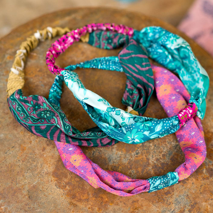Colorful fabric headbands on a rustic wooden surface