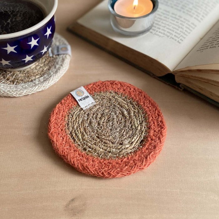 Seagrass coasters with vibrant orange jute edge.