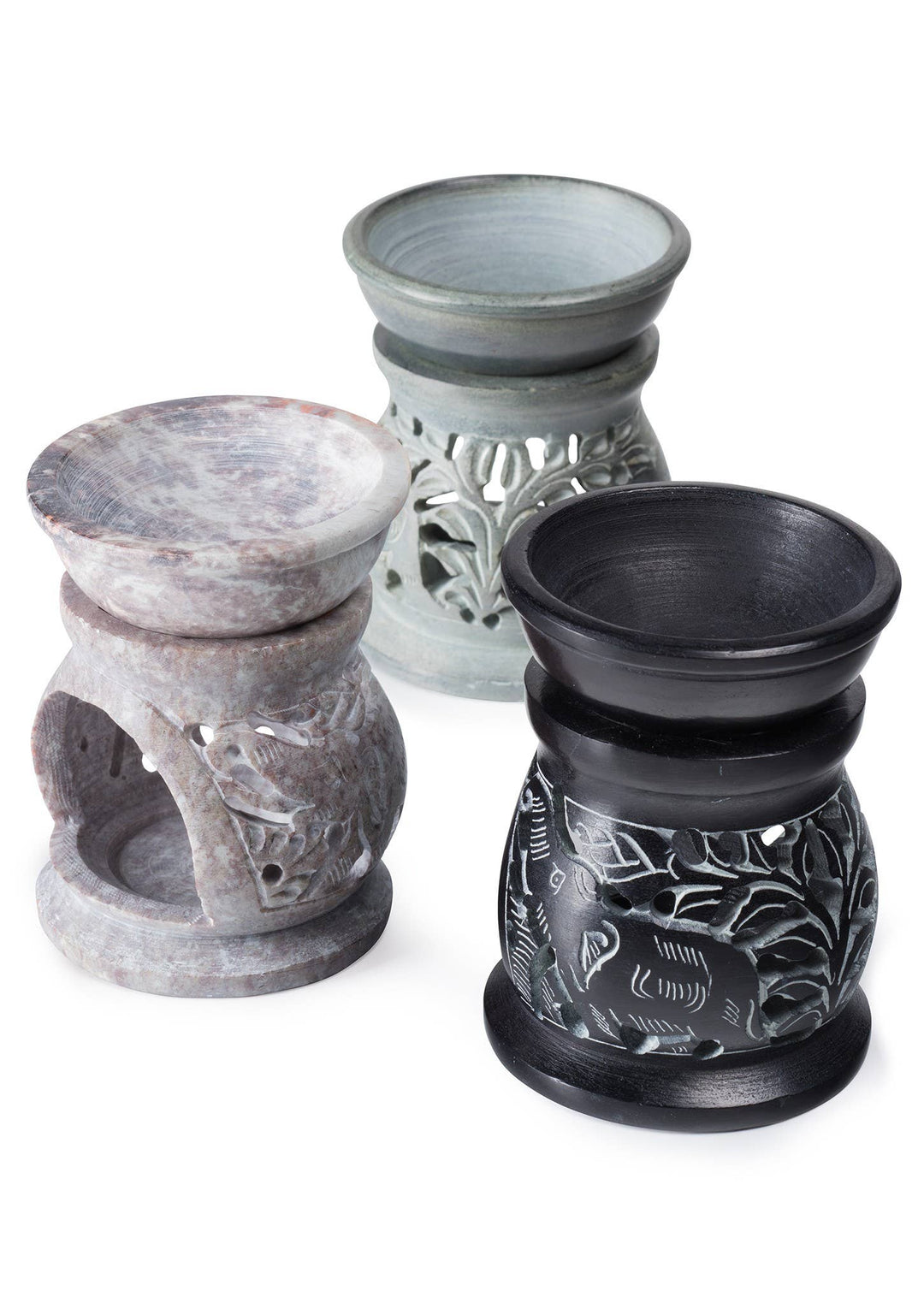 Three stone-like oil burners with intricate designs on a white background