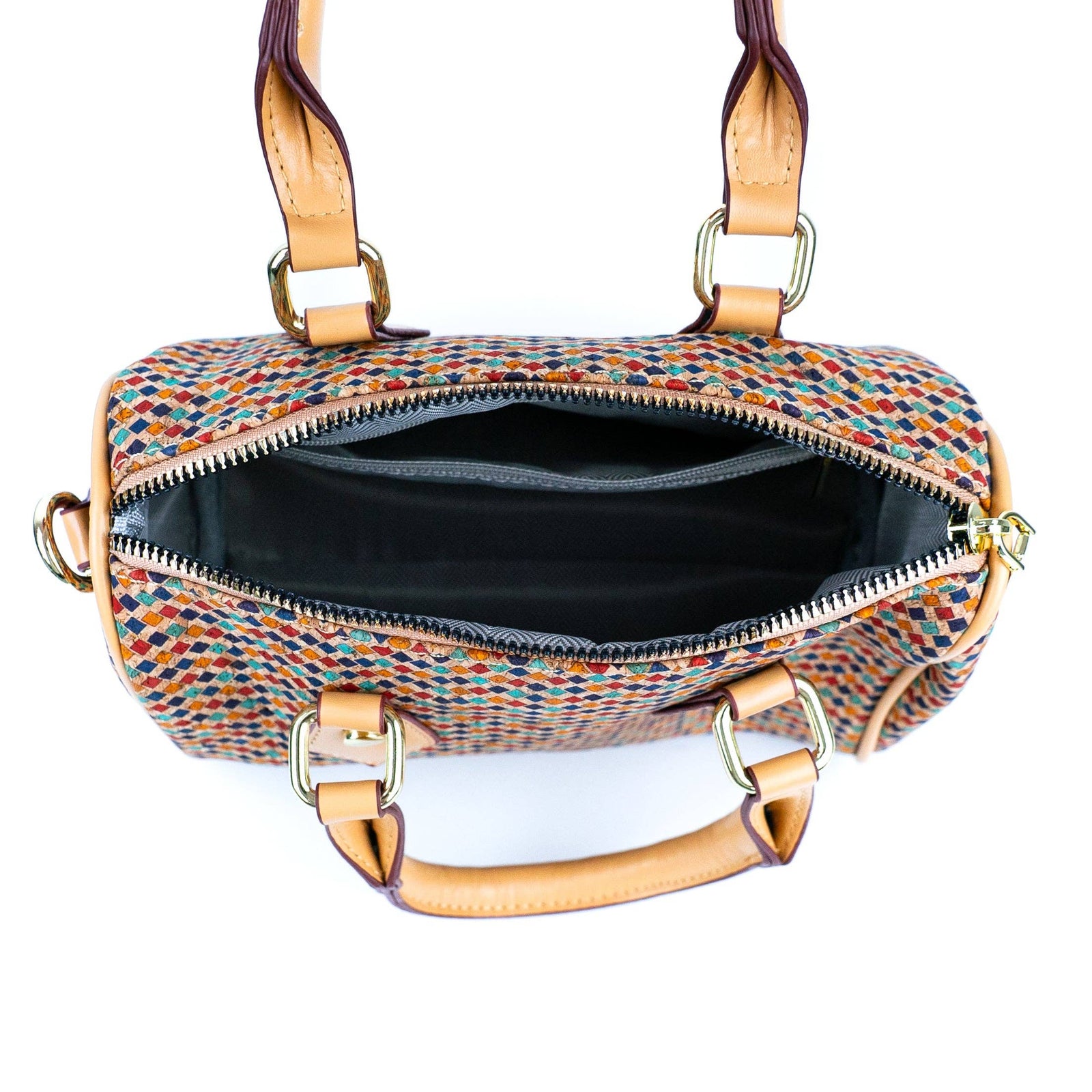 Multicolored patterned handbag with gold accents on a white background