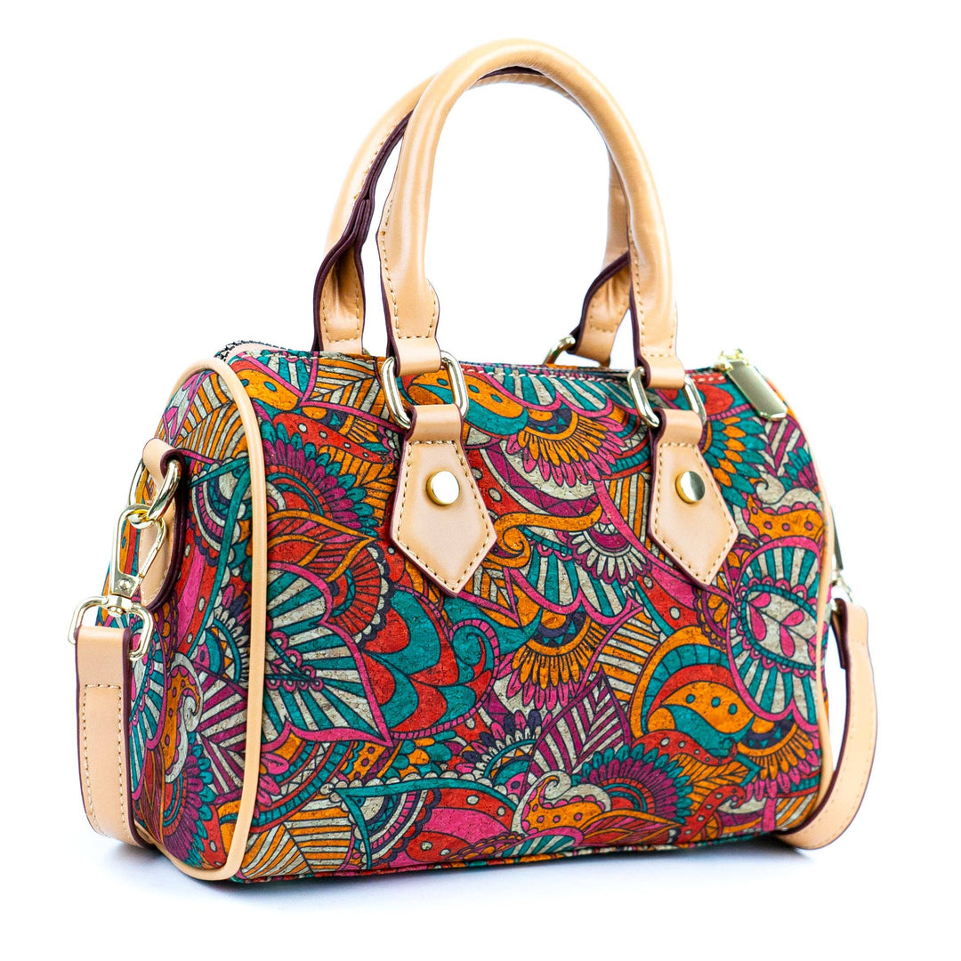 A multicolored floral cork crossbody bucket bag with a beige strap and accents, displayed against a white background.