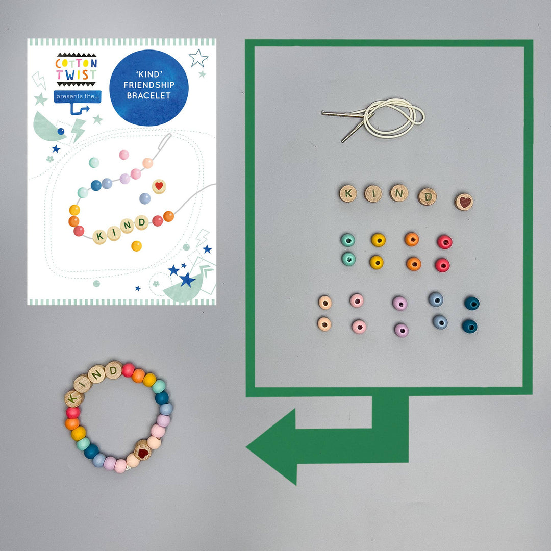 Colourful 'Kind' friendship bracelet kit with instructions and components on a gray background