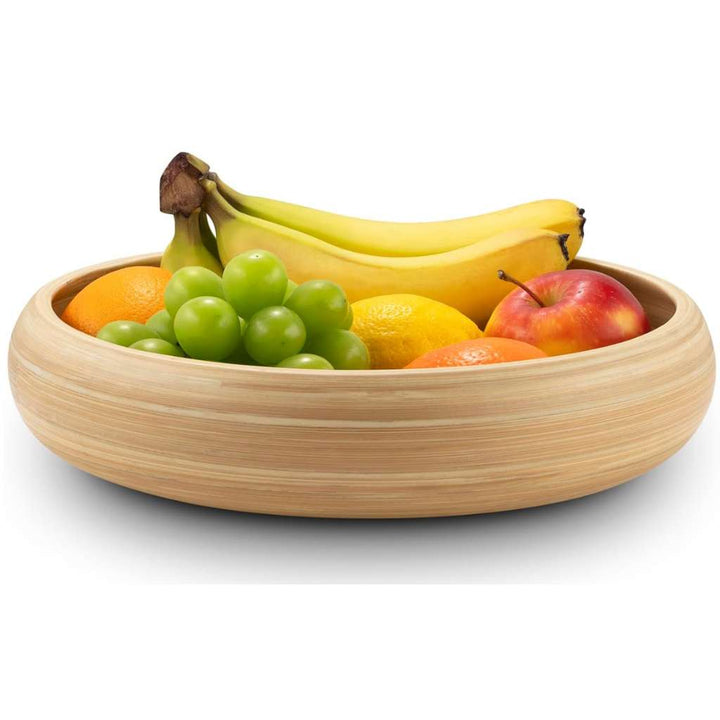 Wooden bowl filled with various fruits on a white background