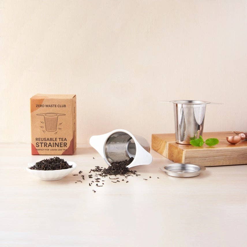 Reusable tea strainer with packaging on a light surface