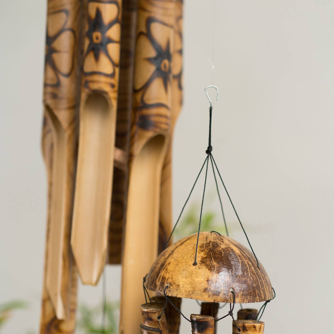 Bamboo wind chime with decorative elements on a light background