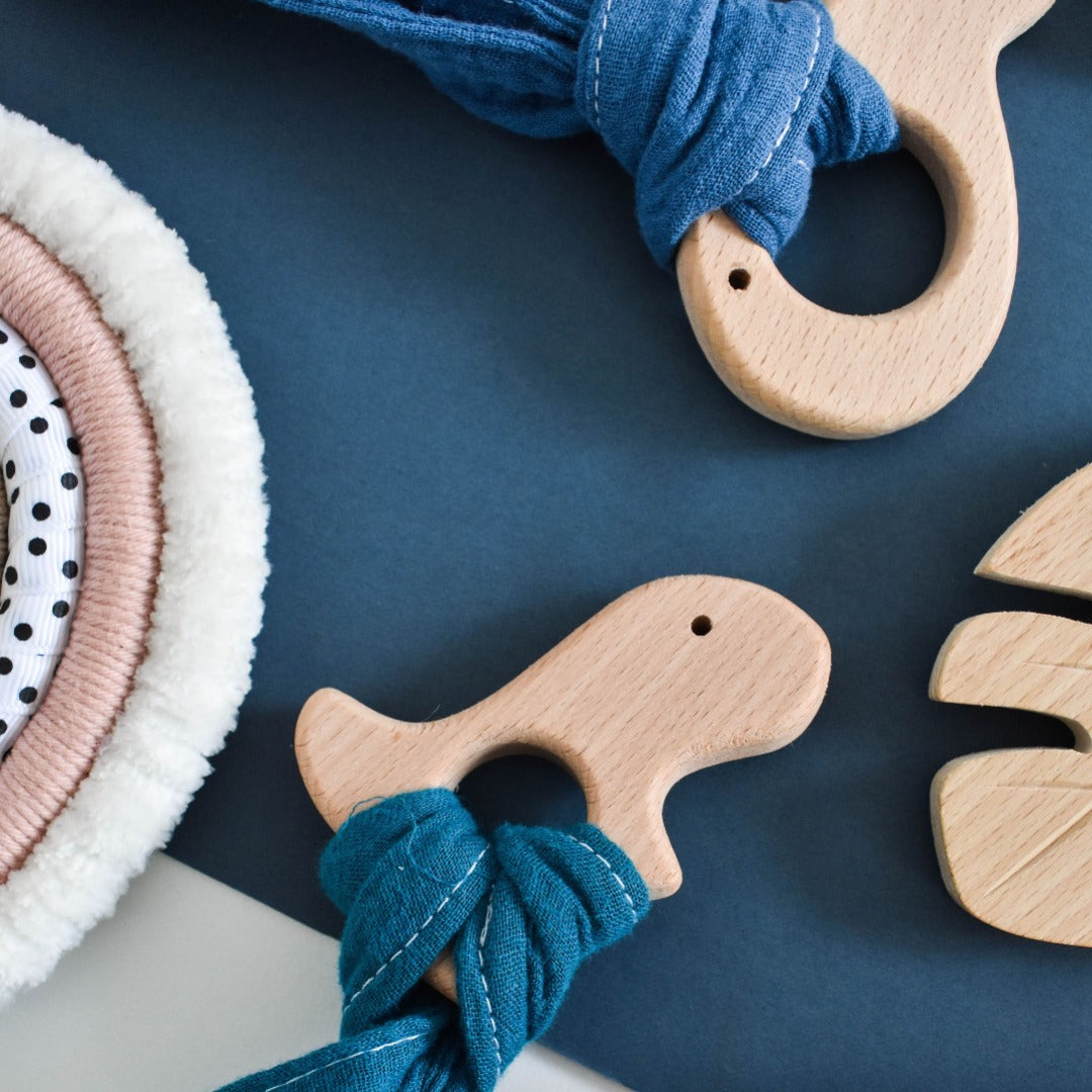 Baby teether - Natural beechwood dinosaur teether with muslin teether strip.