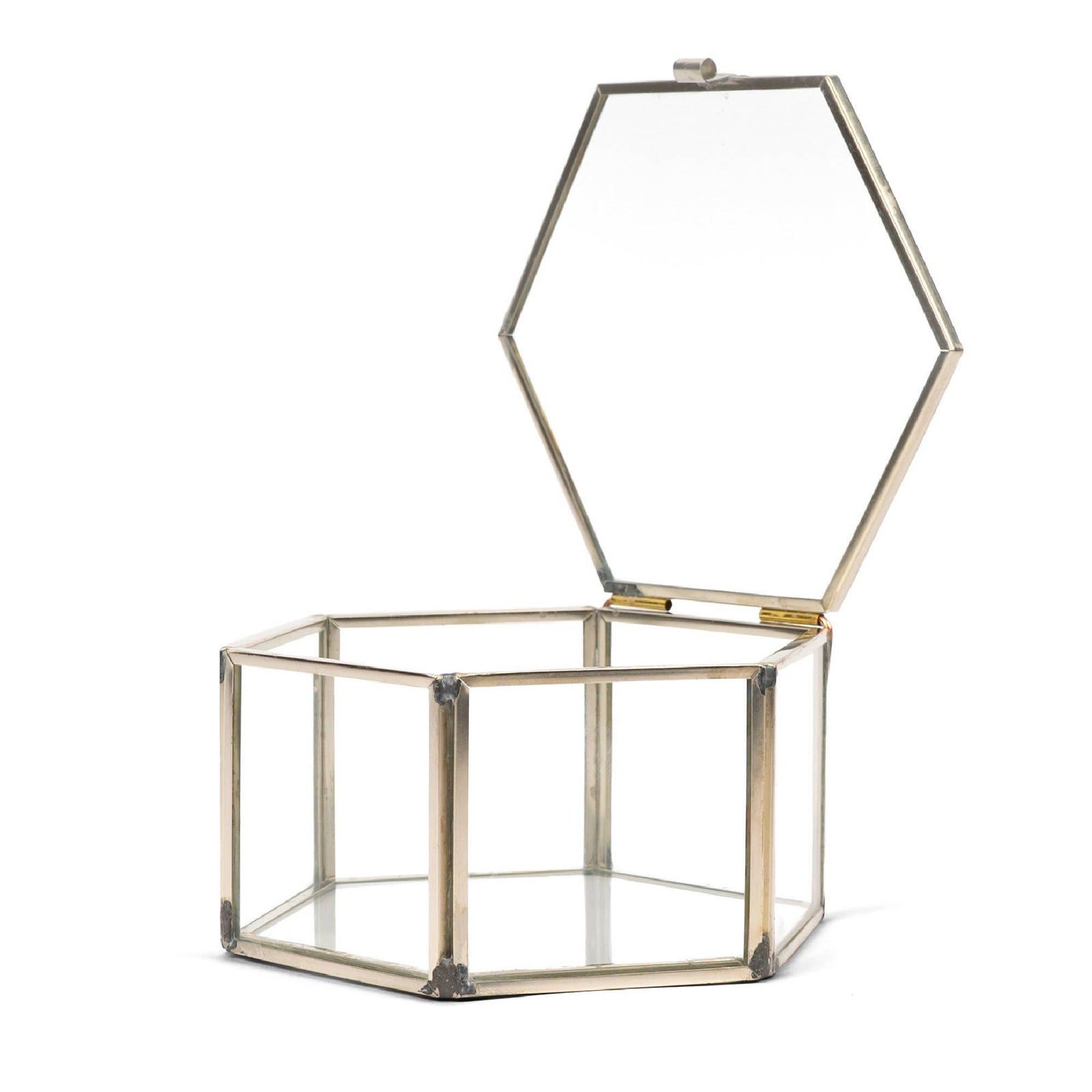 A hexagon-shaped glass jewellery box with a gold-colored copper frame, displayed against a white background.