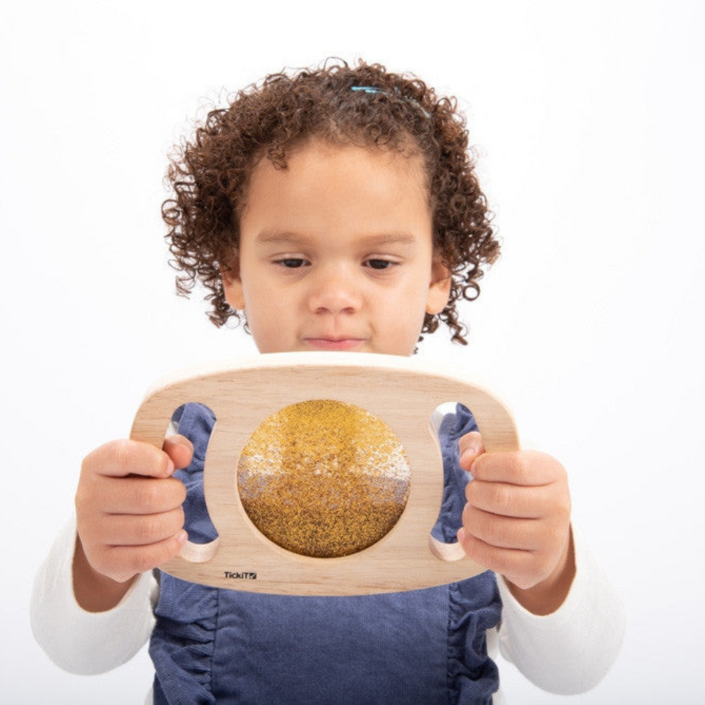 Sensory wooden panel toy with gold glitter. 